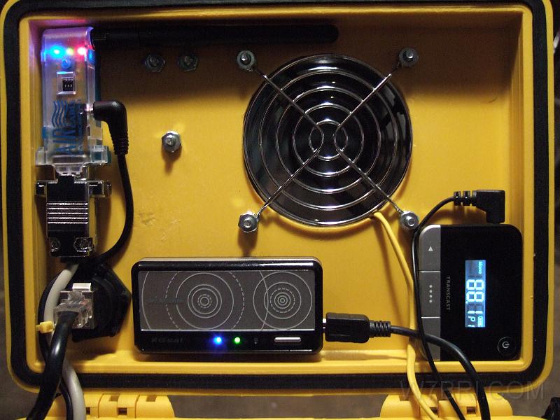 Lid close up.jpg - The bluetooth serial adapter (upper left), bluetooth GPS (center) and FM transmitter (right) are all fired up and ready to go.
